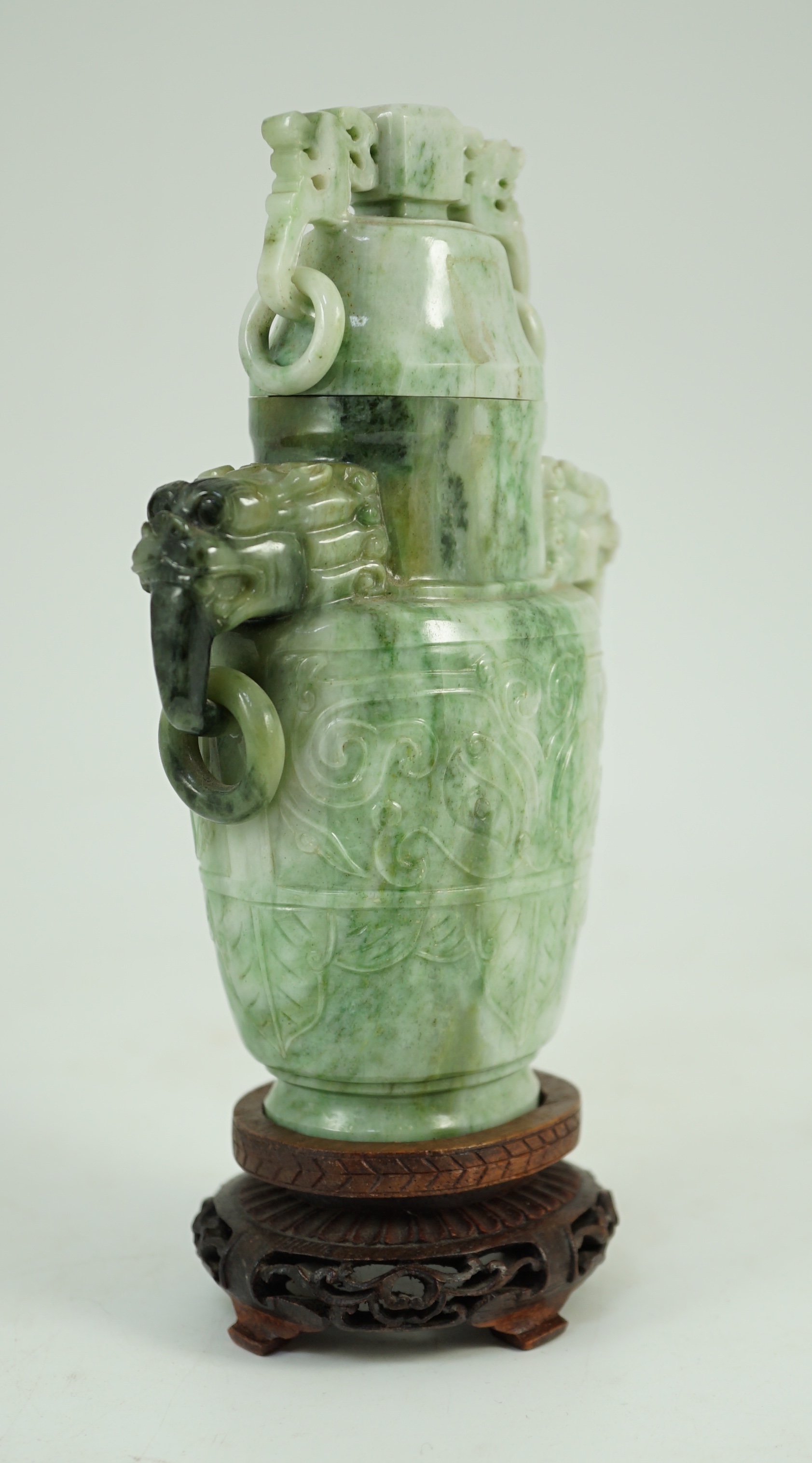 A Chinese archaistic jadeite two-handled vase and cover, first half 20th century, 16 cm high, excluding wood stand